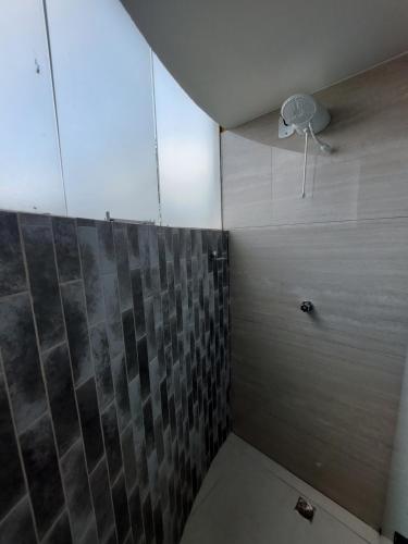 a bathroom with a shower with a toilet in it at Acqua Ville 2 - Apartamentos JN in Caldas Novas