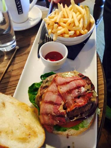 a plate of food with a sandwich and french fries at Villa Bella Boutique Hotel in Kavadarci