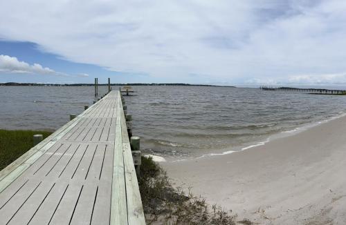 a wooden pier stretches out into the water at Harkers Hideaway - Waterfront with Private Beach in Harkers Island