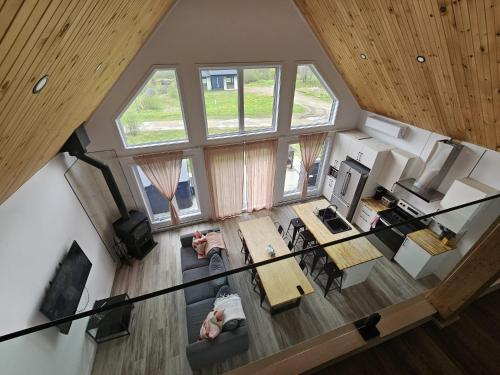 an overhead view of a living room with windows and a table at Le Chal'Heureux in Saint Adelphe