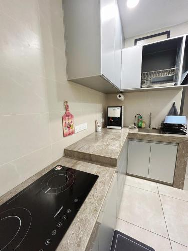 a kitchen with a stove and a counter top at NEW The Sweet Home Bukit Beruang 3Bed 3Bath in Kampong Sungai Putat