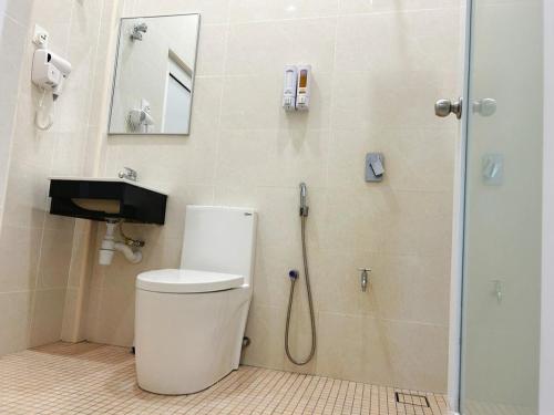 a bathroom with a shower with a toilet and a sink at NEW The Sweet Home Bukit Beruang 3Bed 3Bath in Kampong Sungai Putat