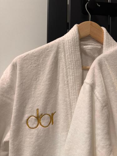 a white towel with the olympics on it at d'or Hotel in Chişinău