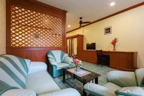 a waiting room with chairs and a table and a desk at The Golddiggers Resort in Nai Yang Beach