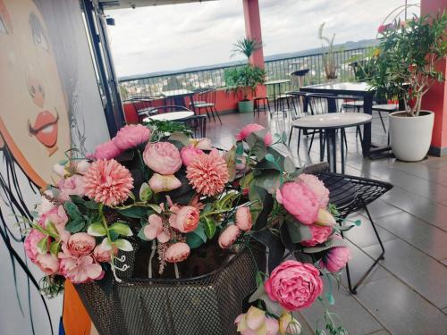 a bunch of pink flowers in a basket on a balcony at Hotel Stylish Binh Long in Binh Long