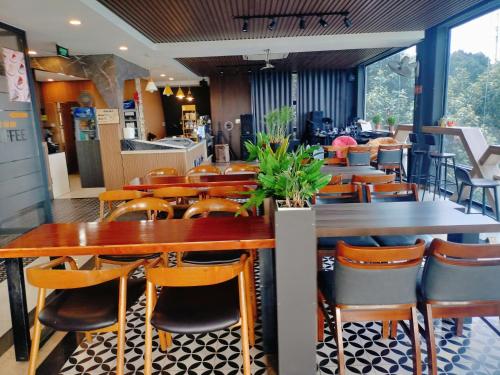 a dining room with wooden tables and chairs at Hotel Stylish Binh Long in Binh Long