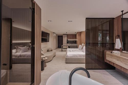 a bathroom with two beds and a tub in a room at Premium Smart Loft with Alexa in El Poblado in Medellín