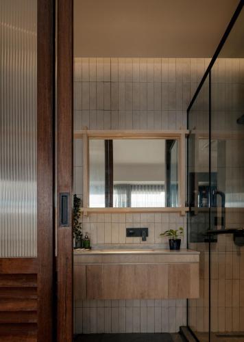 a bathroom with a mirror and a sink at Bishop House in George Town