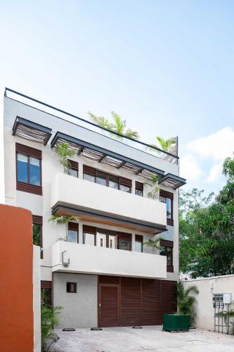 a large white building with a garage at Stylish Double Studio with Equipped Kitchen and Wi-Fi in Bucerías