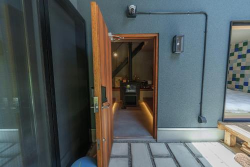 un pasillo que conduce a una habitación con puerta en COCO VILLA 湯布院-Yufuin-, en Yufu