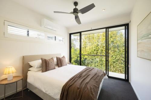 a bedroom with a bed and a ceiling fan at Villa Ponte, 3BR Villa, private pool in New Farm in Brisbane