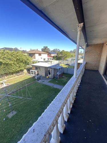 a balcony of a building with a basketball court at Spacious Queen Room in Comfortable Two Story House - L2 