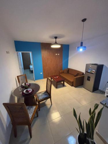a living room with a couch and a table and chairs at La posada ideal in Punta Cana