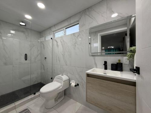 a bathroom with a toilet and a sink and a mirror at Brisa Serena in San Felipe