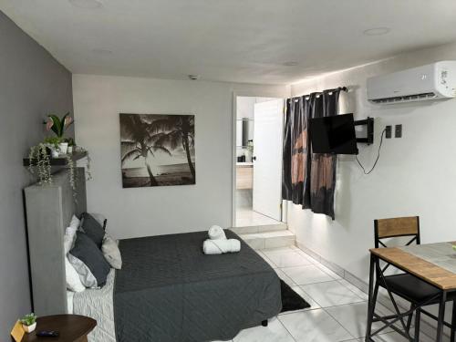a bedroom with a bed and a table and a dining room at Brisa Serena in San Felipe