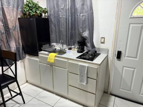 a kitchen with a sink and a tv on a counter at Brisa Serena in San Felipe