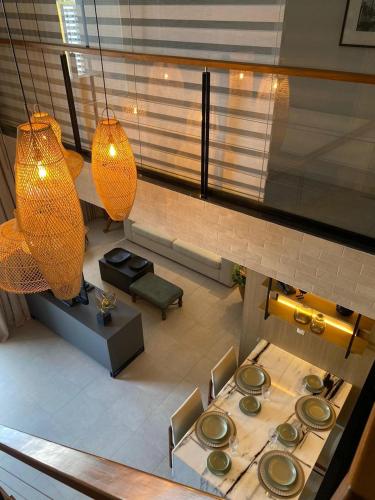 an overhead view of a room with a table and lights at Ed. Connext Loft (ref. Hotel Mercure Boulevard) in Curro Velho