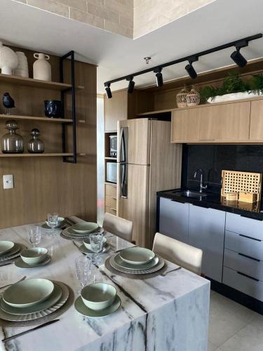 a kitchen with a table with plates on it at Ed. Connext Loft (ref. Hotel Mercure Boulevard) in Curro Velho