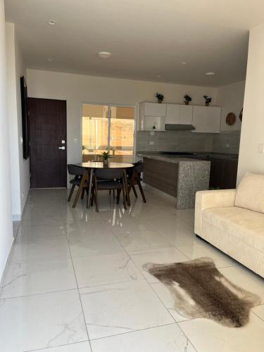 a kitchen and living room with a table and a couch at Rosarito Sol y Mar Getaway in Rosarito Beach