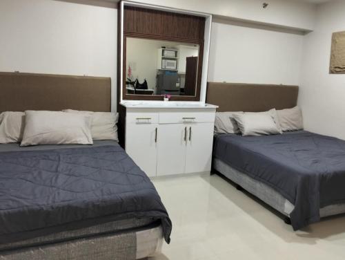 Ένα ή περισσότερα κρεβάτια σε δωμάτιο στο SMDC Style Residence