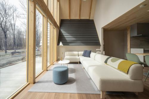 a living room with a couch and a table at ERUSA Rusutsu in Rusutsu