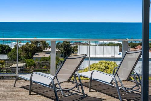 two chairs on a balcony with the ocean in the background at IL Mare - "Expansive Ocean Views" in Apollo Bay