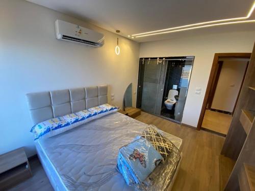 a bedroom with a large bed in a room at Hotel Apartment View Nile Maadi in Cairo