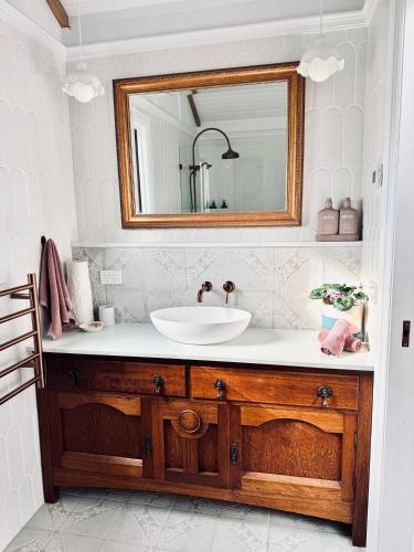 a bathroom with a sink and a mirror at The Orangerie in Hobart