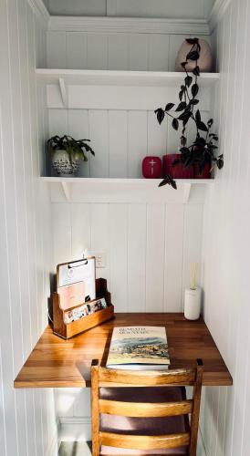 a room with a wooden table with a wooden chair at The Orangerie in Hobart