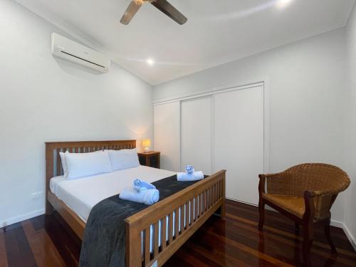 a bedroom with a bed with two towels on it at Debs Shed in Arcadia