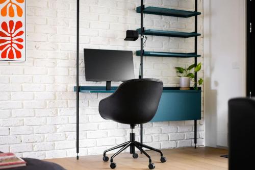 a black chair sitting in front of a desk with a computer at Relaxed Family Coastal Retreat in Leafy Mt Martha in Mount Martha