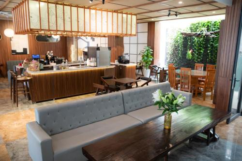 a living room with a couch and a table at HAKU Boutique Hotel Tuy Hoà - APEC Mandala in Tuy Hoa