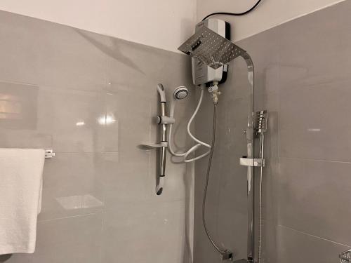 a shower with a shower head in a bathroom at Lagoon Bliss in Ahangama