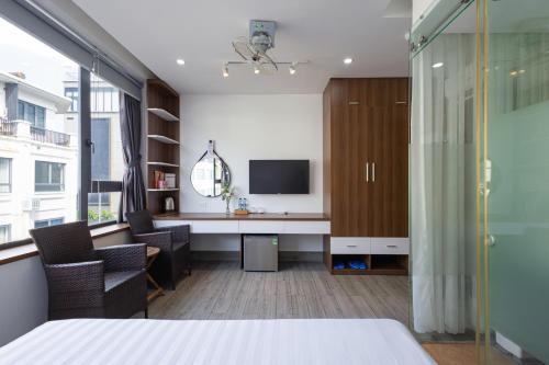 an office with a desk and a tv in a room at HAKU Boutique Hotel Tuy Hoà - APEC Mandala in Tuy Hoa