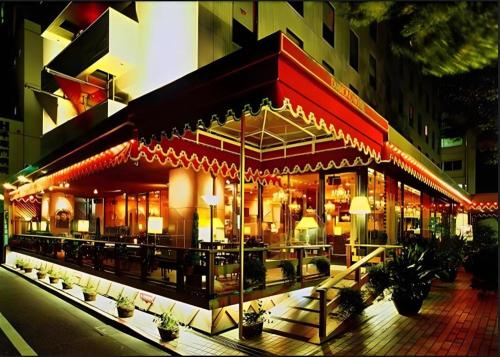 a building with a restaurant with lights on it at Diamond Hotel Tokyo in Tokyo