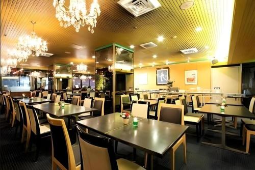 a restaurant with tables and chairs and a chandelier at Diamond Hotel Tokyo in Tokyo