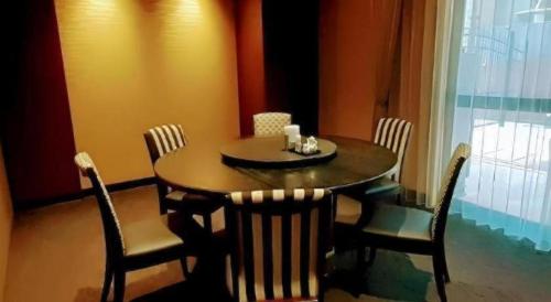 a dining room table and chairs with a table and a window at Diamond Hotel Tokyo in Tokyo