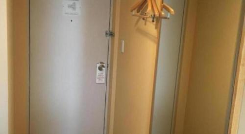 a door in a room with a mirror and a closet at Diamond Hotel Tokyo in Tokyo