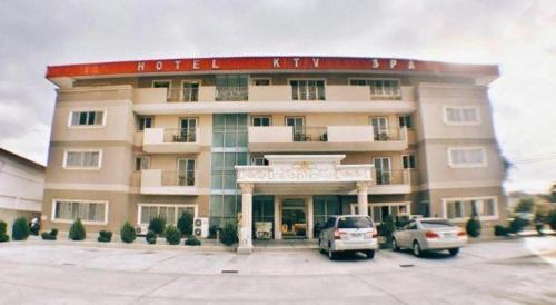 a large building with cars parked in front of it at Grand Hoyah Hotel in Olongapo