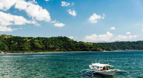 a boat in the middle of a large body of water at Grand Hoyah Hotel in Olongapo