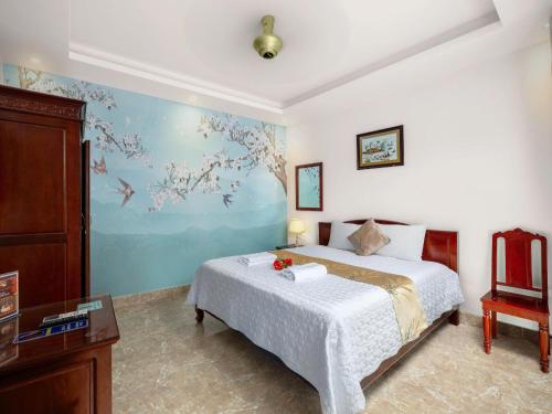 a bedroom with a bed and a painting on the wall at Lys Homestay in Ninh Binh