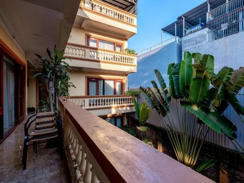 a balcony of a building with a table and plants at Lys Homestay in Ninh Binh