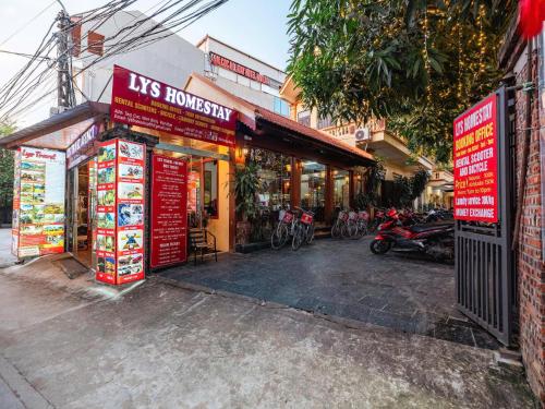 a store with red signs on the side of a street at Lys Homestay in Ninh Binh