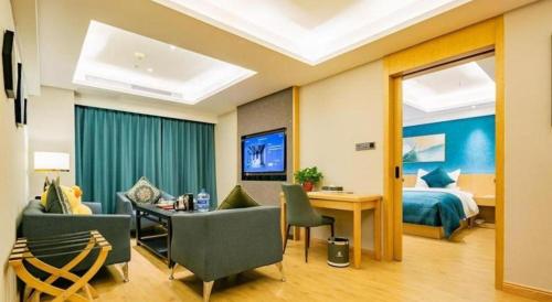 a hotel room with a bed and a desk and chairs at Xian Katie Eastman Hotel in Xi'an