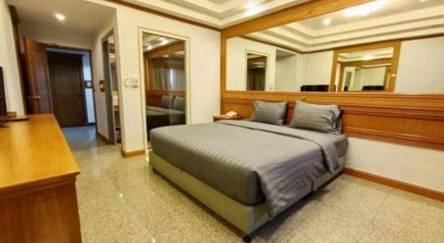 a bedroom with a large bed in a room at New Siya in Maha Sarakham