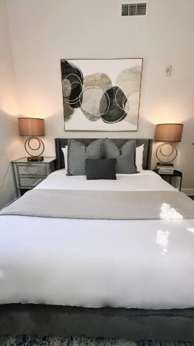 a bedroom with a large white bed with two lamps at Downtown 5B2B Apt, Sleeps 10, Near PPAC & Events in Providence