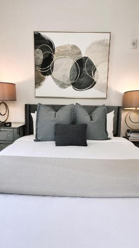 a bedroom with a large white bed with two lamps at Downtown 5B2B Apt, Sleeps 10, Near PPAC & Events in Providence