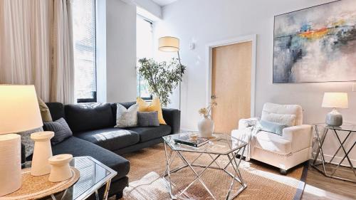 a living room with a couch and a table at Downtown 5B2B Apt, Sleeps 10, Near PPAC & Events in Providence