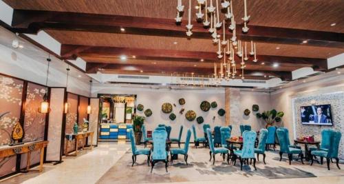 a dining room with blue chairs and a table at Bati Holiday Hotel in Zhongshan