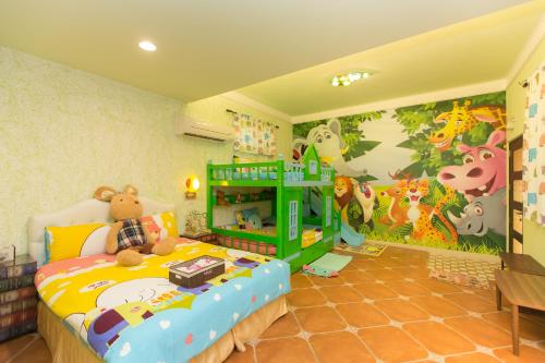 a childs bedroom with a bed with a dinosaur mural at The Anderson Manor Hotel in Ruisui